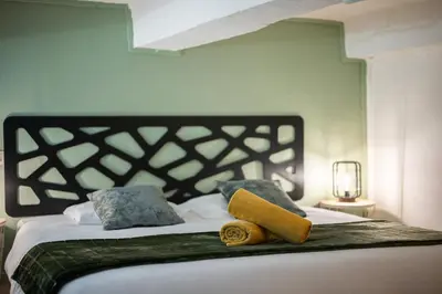 a bed with two pillows on top of it at Spacieux Loft & Central- Vieux Nice in Nice