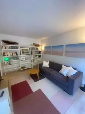 a living room with a couch and a table at Lovely studio apartment in Nice