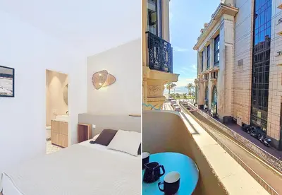 a bedroom with a bed and a view of a city at Nestor&Jeeves - PALMIERS TERRASSE - Central - Terrace in Nice