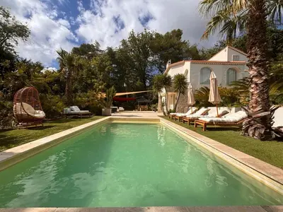 a house with a swimming pool in front of a house at Luxury Riviera Villa* short walk to beach & center in Cagnes-sur-Mer
