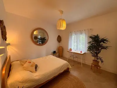 a bedroom with a bed with a mirror on the wall at Luxury Riviera Villa* short walk to beach & center in Cagnes-sur-Mer