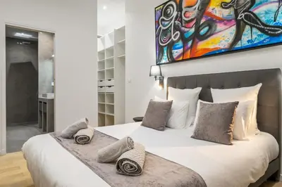 a bedroom with a large white bed with pillows at La Galerie 58 - Luxe & Design en centre ville in Nice