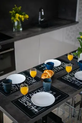 a table with plates and glasses of orange juice at La Galerie 58 - Luxe & Design en centre ville in Nice