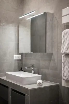 a bathroom with a white sink and a mirror at La Galerie 58 - Luxe & Design en centre ville in Nice