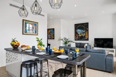 a kitchen and living room with a table and a couch at La Galerie 58 - Luxe & Design en centre ville in Nice