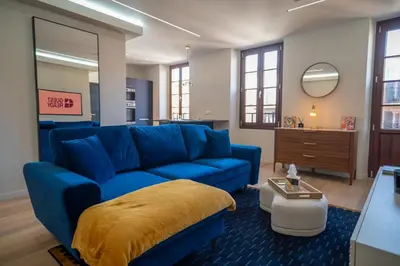 a living room with a blue couch and a mirror at GuestReady - Lovely Getaway in Nice
