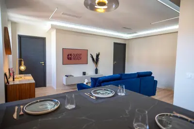 a living room with a table and a blue couch at GuestReady - Lovely Getaway in Nice