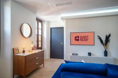 a living room with a blue couch and a mirror at GuestReady - Lovely Getaway in Nice