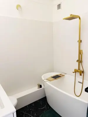 a white bathroom with a tub and a shower at Studio Carré Or - Centre Nice 2m à pied de la mer in Nice