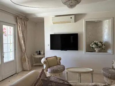 a living room with a couch and a table and a tv at Villa Gloria Nouvel Hôte in Saint-Jeannet