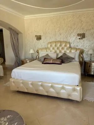 a bedroom with a large bed with a leather headboard at Villa Gloria Nouvel Hôte in Saint-Jeannet