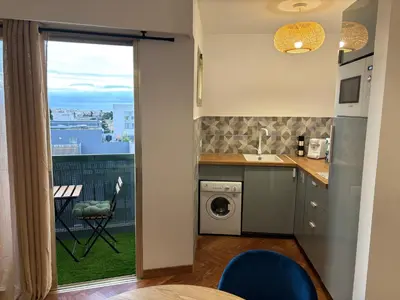 a kitchen with a sink and a washing machine at Elégant studio de 25m2 in Saint-Laurent-du-Var
