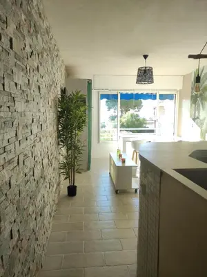 a kitchen with a stone wall and a counter at Studio vue mer in Cagnes-sur-Mer
