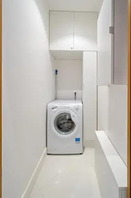 a washing machine in a white laundry room at Cosy 2P Promenade des Anglais in Nice