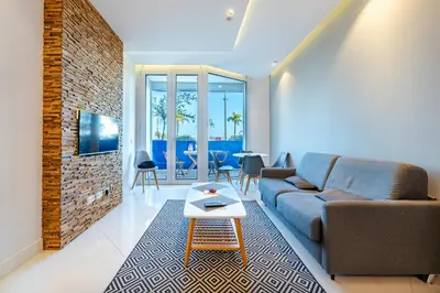a living room with a couch and a table at Cosy 2P Promenade des Anglais in Nice