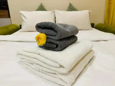 a pile of towels sitting on top of a bed at Amber Apartment Nice - Central Highlights and Beach in Nice