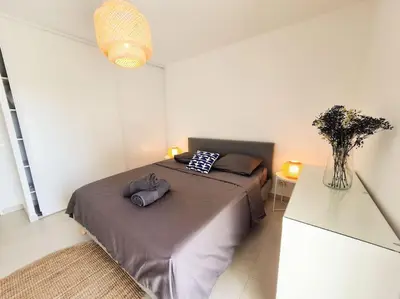 a bedroom with a bed with two pillows on it at Magnifique Appartement - Parking privé - Nice in Nice