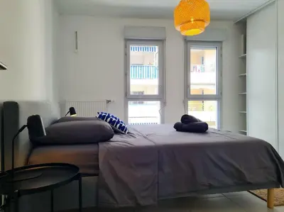 a bedroom with a bed with two pillows on it at Magnifique Appartement - Parking privé - Nice in Nice