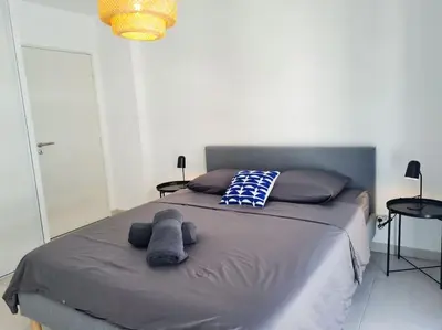 a bedroom with a bed with two stuffed animals on it at Magnifique Appartement - Parking privé - Nice in Nice