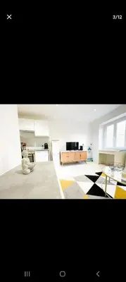 a large living room with a couch and a television at Joli appartement centre de Nice in Nice