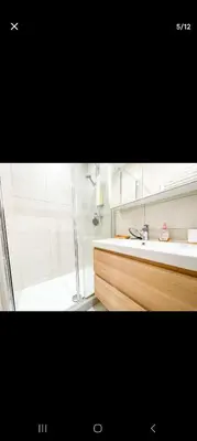 a bathroom with a shower and a white sink at Joli appartement centre de Nice in Nice