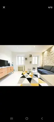 a bedroom with a bed and a checkerboard floor at Joli appartement centre de Nice in Nice