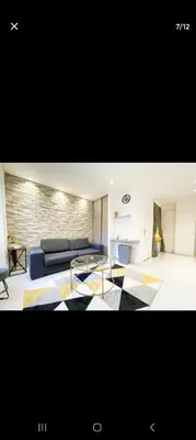 a living room with a couch and a table at Joli appartement centre de Nice in Nice
