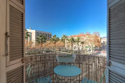 a balcony with a table and chairs on a balcony at Lovely 2 bedroom Apartment in Nice with Balcony in Nice