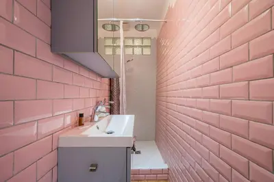 a bathroom with a sink and a pink brick wall at Lovely 2 bedroom Apartment in Nice with Balcony in Nice