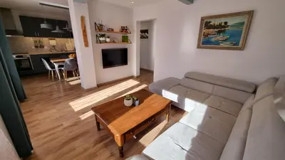 a living room with a couch and a table at T3 au calme à deux pas de la mer in Nice