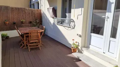 a patio with a table and chairs on a balcony at T3 au calme à deux pas de la mer in Nice