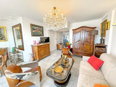a living room with a couch and a chandelier at Breathtaking Rooftop Experience on Promenade in Nice