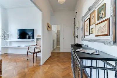 a living room with a table and a chair at Elegant Condo with Balconies in the Heart of Nice in Nice