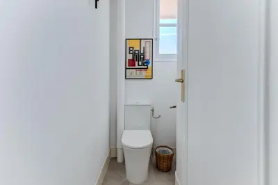 a bathroom with a toilet and a picture on the wall at Elegant Condo with Balconies in the Heart of Nice in Nice