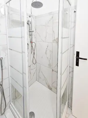 a shower with a glass door in a bathroom at New Big Flat 8 Pers AC WiFi in Nice