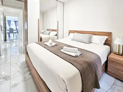 a bedroom with a large bed with towels on it at New Big Flat 8 Pers AC WiFi in Nice