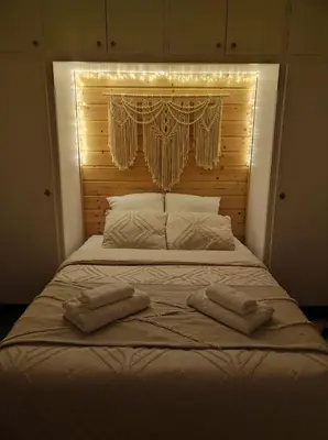 a bed with two towels on it with lights on it at Chambre à 3 min de la Promenade des Anglais à pieds 200m in Nice