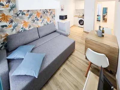a living room with a gray couch and a white chair at Lamartine 3 Pers Central WiFi AC in Nice