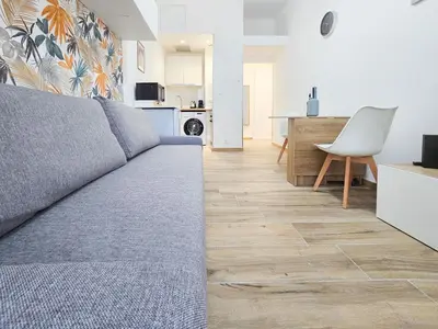 a living room with a couch and a kitchen at Lamartine 3 Pers Central WiFi AC in Nice
