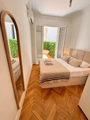 a bedroom with a large bed and a mirror at Luxury Central Condo with Private Terrace in Nice in Nice