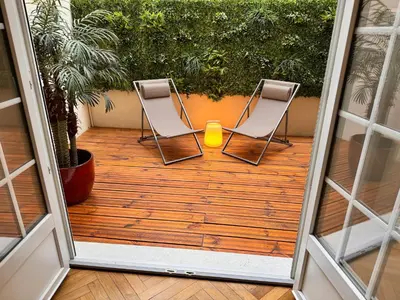 two chairs on a deck with a candle in the middle at Luxury Central Condo with Private Terrace in Nice in Nice