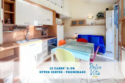 a kitchen with a table and some chairs in it at Barralis Hyper Center 2 Pers AC WiFi in Nice