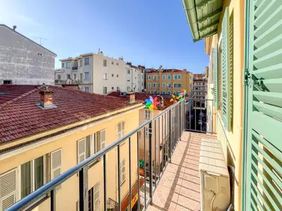 a balcony of a building with flags on it at Barralis Hyper Center 2 Pers AC WiFi in Nice