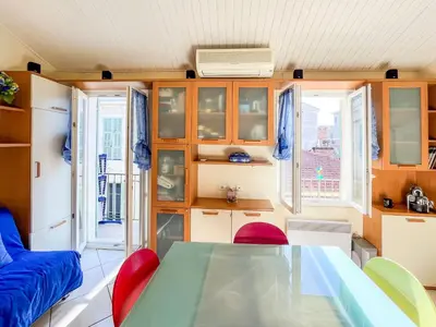 a kitchen and dining room with a table and chairs at Barralis Hyper Center 2 Pers AC WiFi in Nice