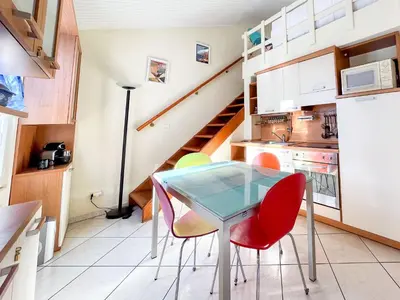 a small kitchen with a glass table and chairs at Barralis Hyper Center 2 Pers AC WiFi in Nice