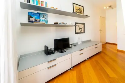 a living room with a tv on a counter at Palais Magnan 4 Pers WiFi AC in Nice