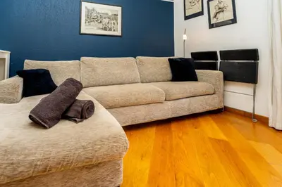 a living room with a couch and a wooden floor at Palais Magnan 4 Pers WiFi AC in Nice