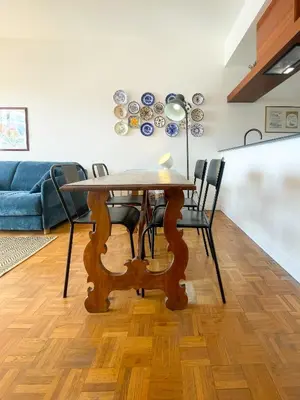 a dining room table with chairs and a blue couch at Paradise 4 Pers Vista Mare Wifi AC in Nice