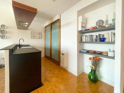 a kitchen with a black counter and a vase with flowers at Paradise 4 Pers Vista Mare Wifi AC in Nice