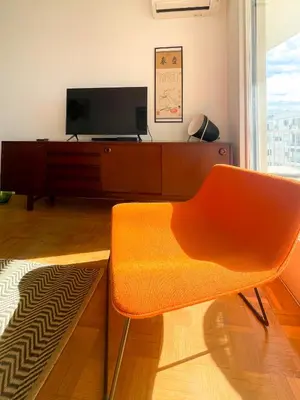 a living room with a tv and a chair at Paradise 4 Pers Vista Mare Wifi AC in Nice